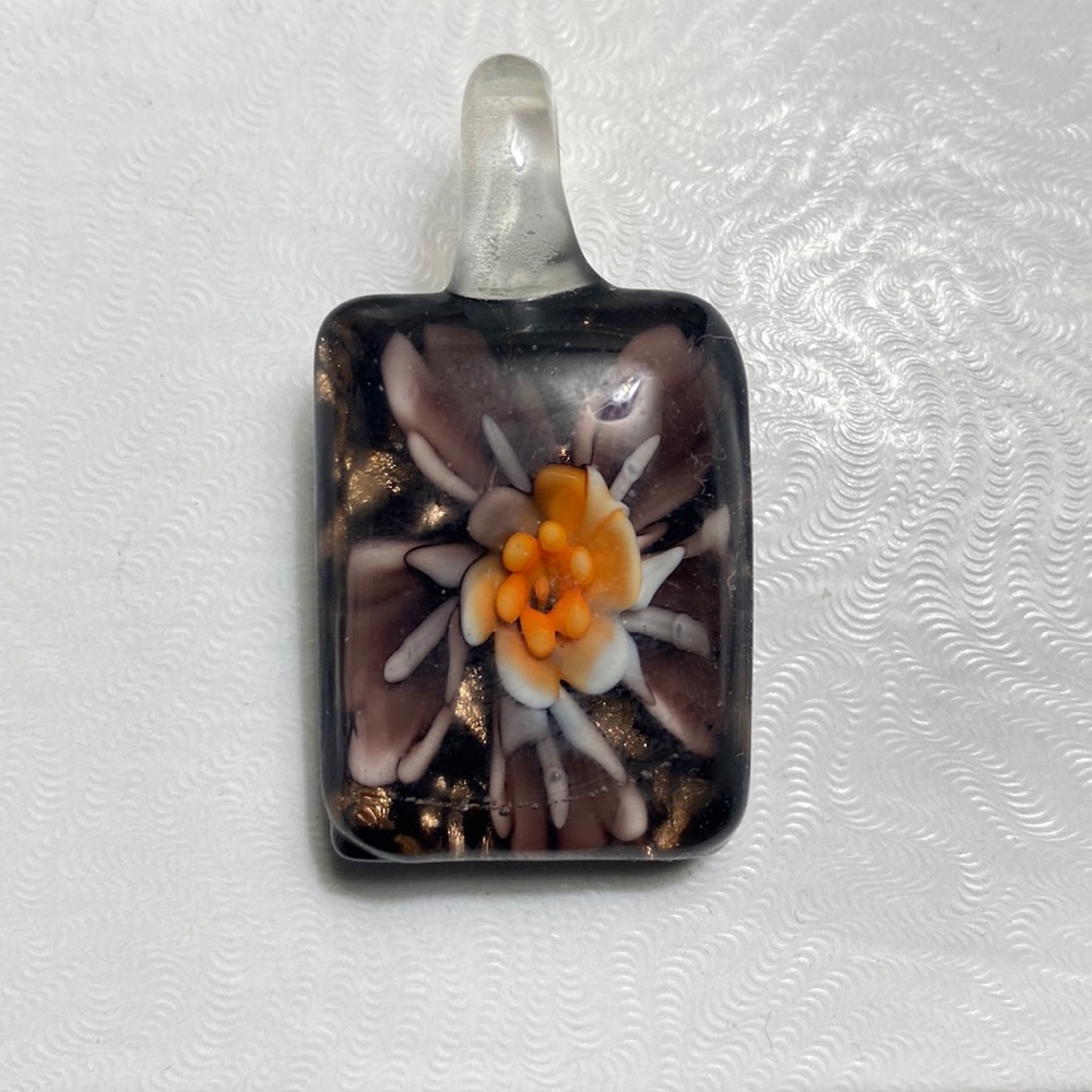 LEAVING CLOSET! Glass charm. No chain. Purple flowers on 1 side. Black on other.